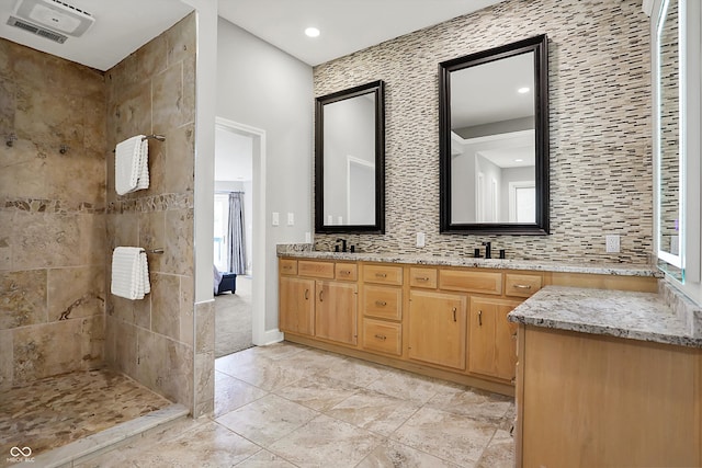 full bathroom featuring a tile shower, a sink, double vanity, recessed lighting, and visible vents