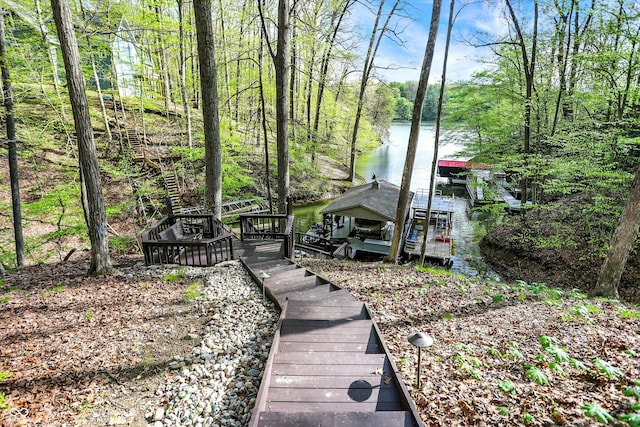 exterior space featuring a water view and a floating dock