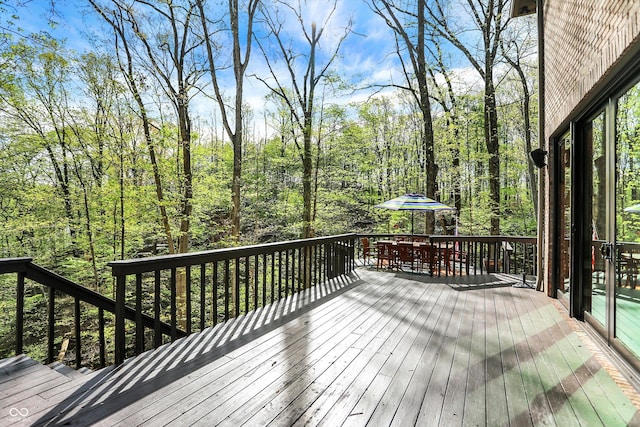 wooden terrace featuring outdoor dining area