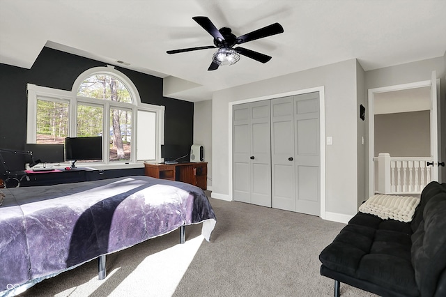 bedroom with ceiling fan, carpet, baseboards, visible vents, and a closet