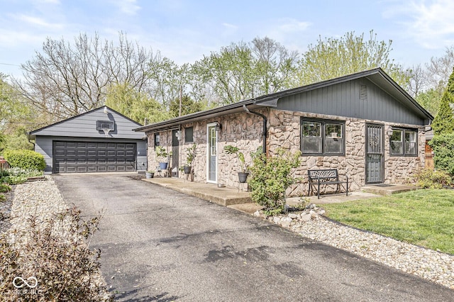 view of front of home with a garage and stone siding