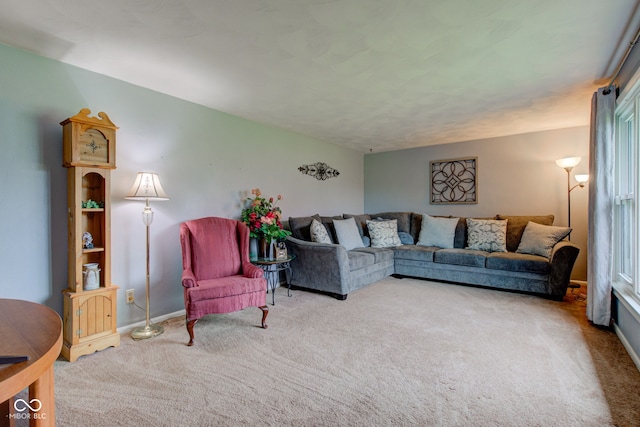 living area featuring carpet floors and baseboards