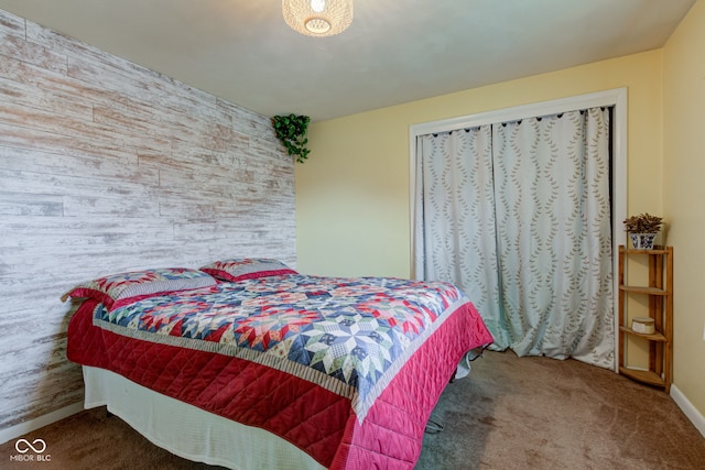 carpeted bedroom featuring baseboards