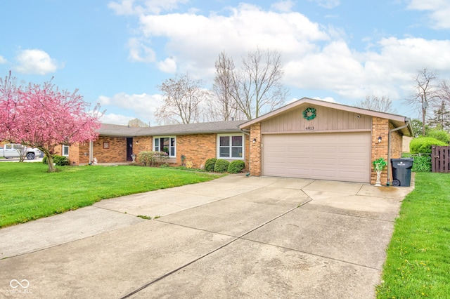 single story home with brick siding, an attached garage, a front yard, and concrete driveway