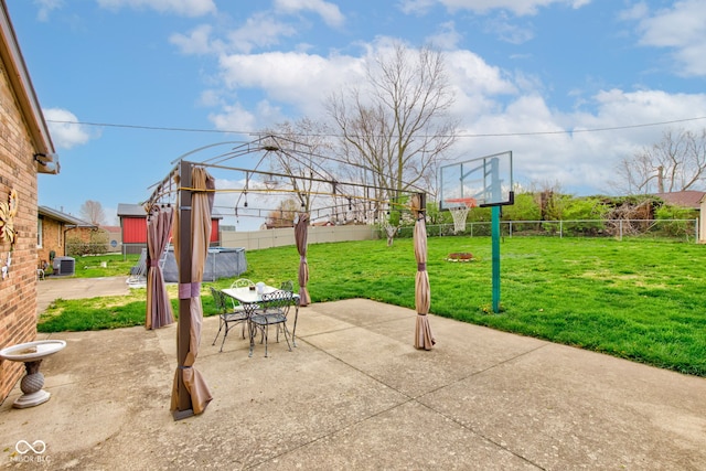 view of patio featuring central air condition unit, outdoor dining space, and a fenced backyard