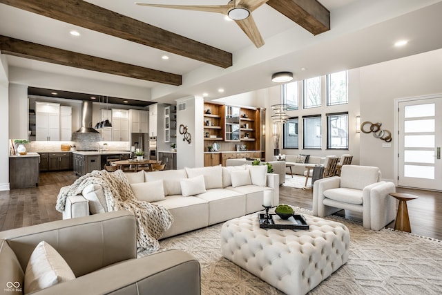 living area featuring a healthy amount of sunlight, ceiling fan, recessed lighting, and wood finished floors