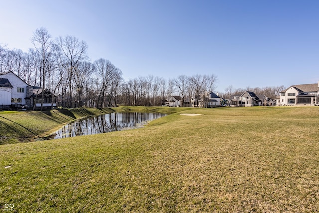 view of yard with a water view and a residential view