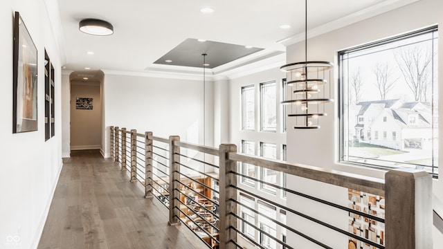 hallway with wood finished floors, baseboards, an upstairs landing, ornamental molding, and recessed lighting
