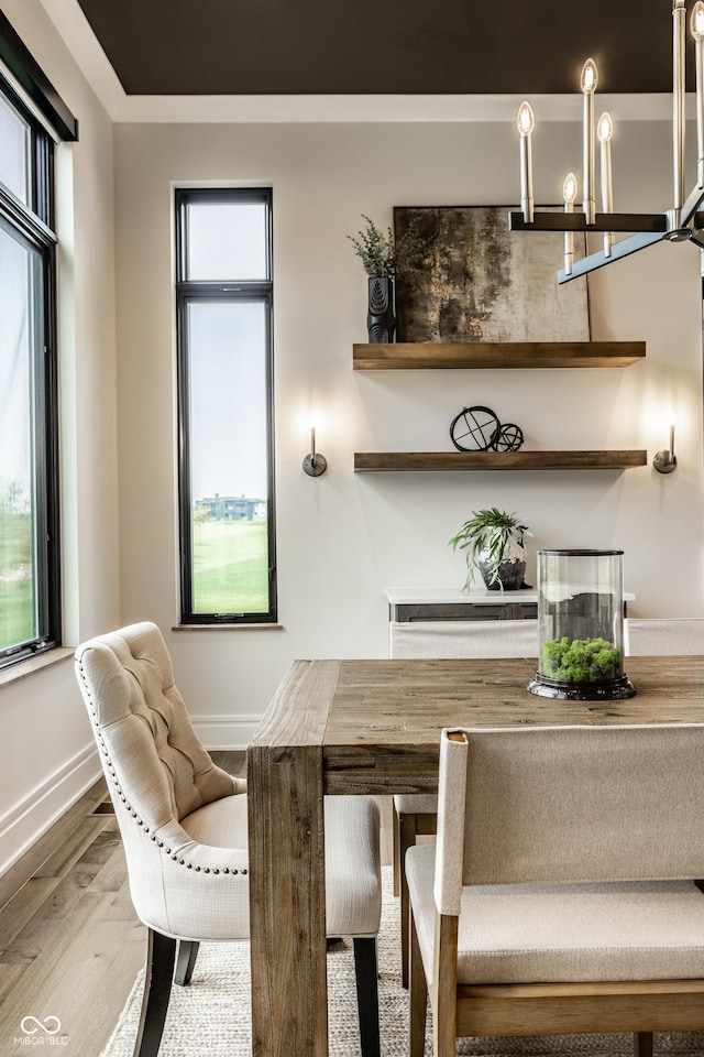 dining area featuring a healthy amount of sunlight, baseboards, and wood finished floors