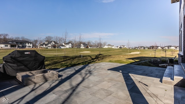 view of patio featuring a residential view and a grill