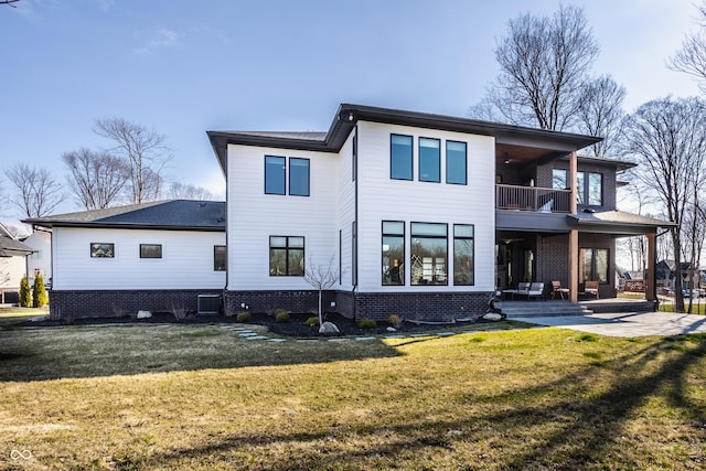 back of house with a ceiling fan, central AC unit, a balcony, a yard, and a patio