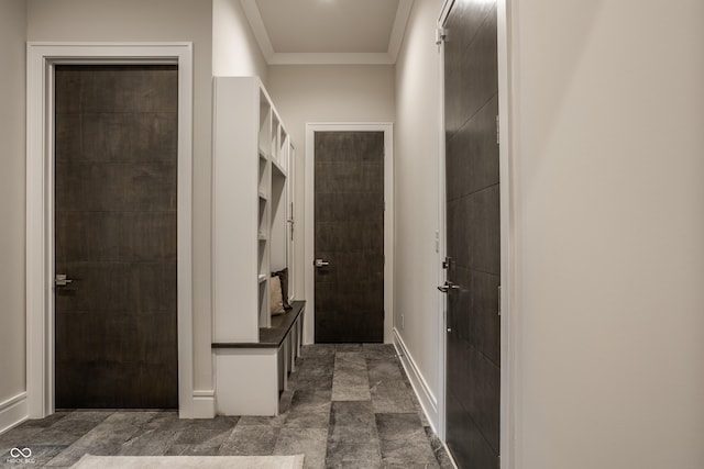 hallway with baseboards and ornamental molding