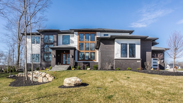prairie-style home featuring french doors, brick siding, and a front yard