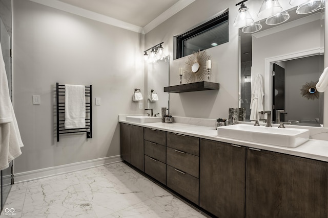 bathroom with double vanity, marble finish floor, radiator, ornamental molding, and a sink
