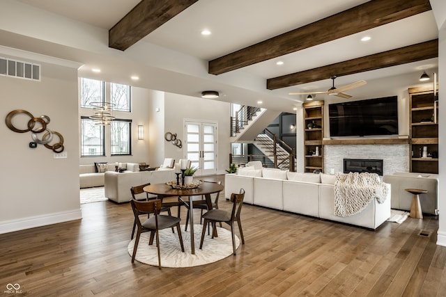 dining room featuring ceiling fan, visible vents, plenty of natural light, and a fireplace