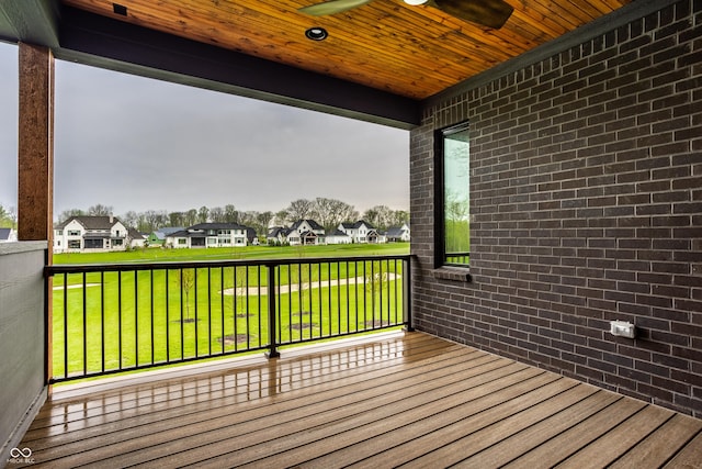 wooden deck featuring a lawn and a residential view