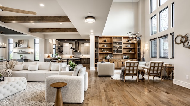 living room with recessed lighting, baseboards, wood finished floors, and beam ceiling