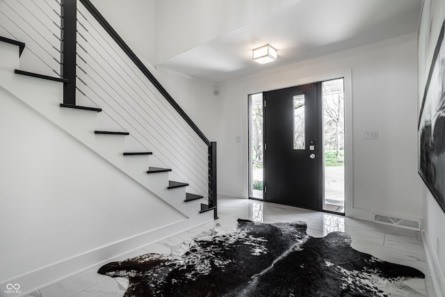 1995 W 116th St, Carmel, IN 46032 - foyer entrance featuring visible vents, ornamental molding, marble finish floor, stairs, and baseboards