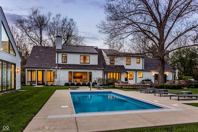 1995 W 116th St, Carmel, IN 46032 - rear view of house featuring a patio, an outdoor pool, a lawn, and a chimney