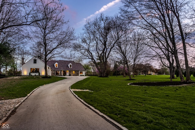 1995 W 116th St, Carmel, IN 46032 - view of community featuring a garage, a yard, and driveway