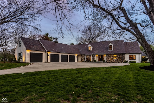 1995 W 116th St, Carmel, IN 46032 - view of front facade with driveway, a front lawn, stone siding, and a garage