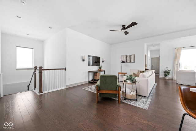 living area featuring baseboards, ceiling fan, plenty of natural light, and wood finished floors