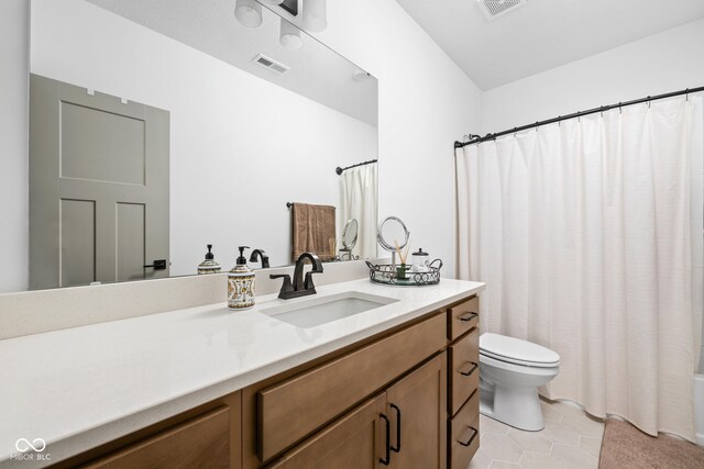 bathroom with toilet, tile patterned floors, visible vents, and vanity