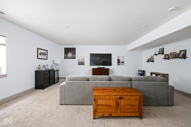 living area featuring light colored carpet, a dry bar, and baseboards