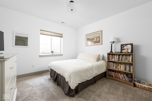 carpeted bedroom featuring baseboards and visible vents