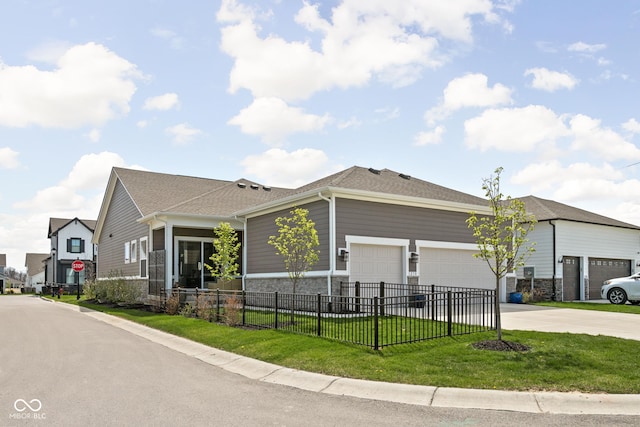 view of front facade featuring a garage, a front lawn, fence, stone siding, and driveway
