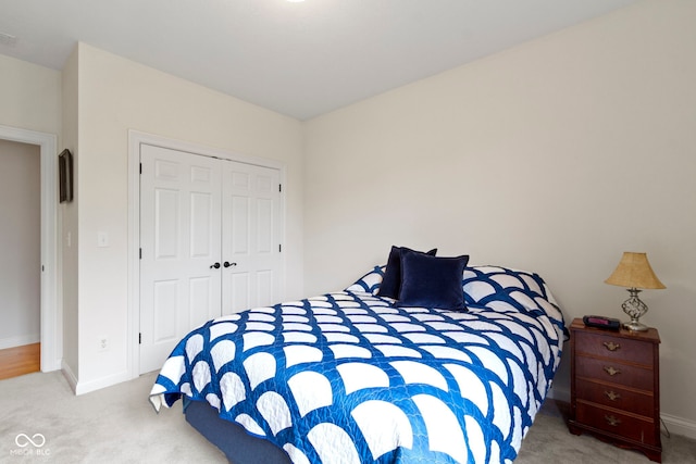 bedroom featuring a closet, carpet flooring, and baseboards