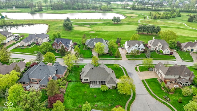 aerial view with a residential view, a water view, and golf course view