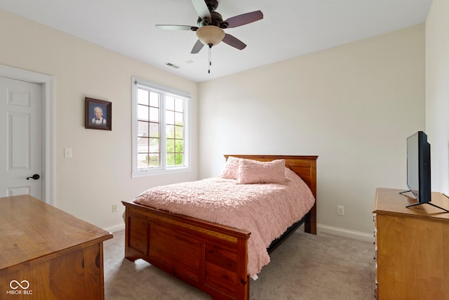 bedroom with visible vents, baseboards, and light carpet