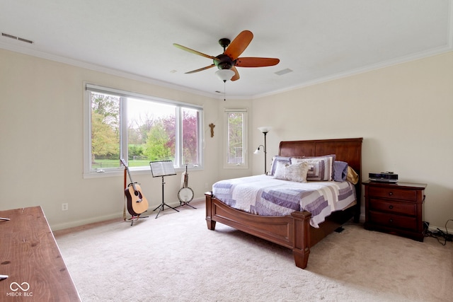 carpeted bedroom featuring baseboards, visible vents, ornamental molding, and ceiling fan