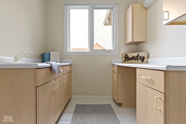 interior space featuring vanity, baseboards, and tile patterned floors