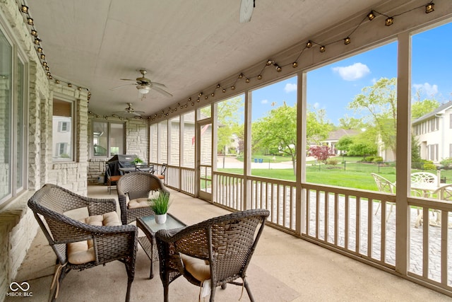 sunroom featuring plenty of natural light and a ceiling fan