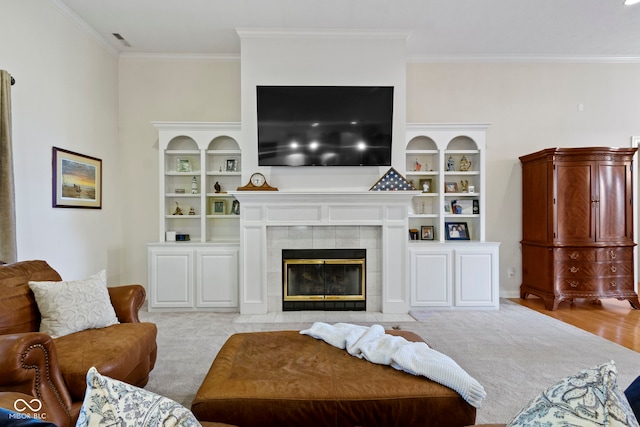 living area featuring visible vents, ornamental molding, carpet, and a fireplace