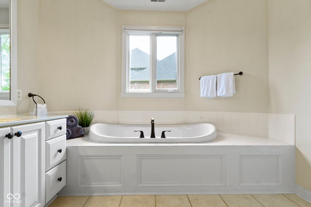full bath featuring vanity, tile patterned flooring, and a garden tub