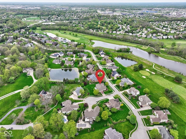 bird's eye view featuring a water view, view of golf course, and a residential view