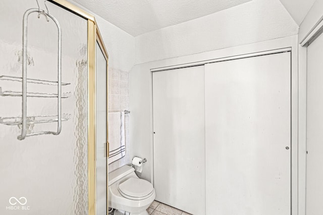 5747 Allisonville Rd, Indianapolis, IN 46220 - bathroom with toilet, a stall shower, and tile patterned flooring