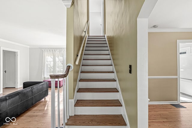 5747 Allisonville Rd, Indianapolis, IN 46220 - stairway with baseboards, wood finished floors, and crown molding