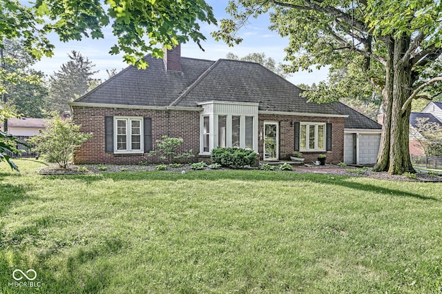 5747 Allisonville Rd, Indianapolis, IN 46220 - view of front of house featuring a front lawn, a chimney, a garage, and brick siding