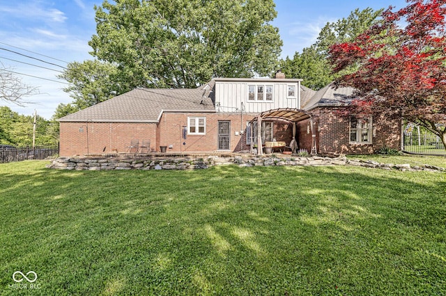 5747 Allisonville Rd, Indianapolis, IN 46220 - rear view of property featuring a chimney, board and batten siding, a yard, brick siding, and fence