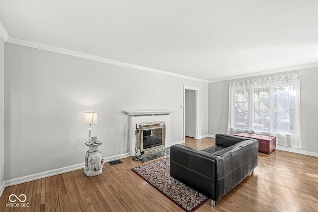 5747 Allisonville Rd, Indianapolis, IN 46220 - living area with ornamental molding, a fireplace, wood finished floors, and baseboards