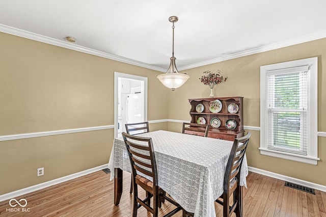 5747 Allisonville Rd, Indianapolis, IN 46220 - dining area featuring visible vents, hardwood / wood-style flooring, ornamental molding, and baseboards