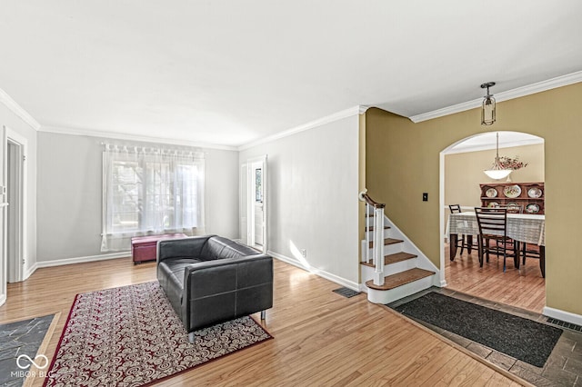 5747 Allisonville Rd, Indianapolis, IN 46220 - living room with visible vents, arched walkways, ornamental molding, and light wood finished floors