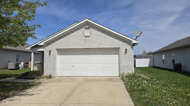 garage with central AC unit and fence