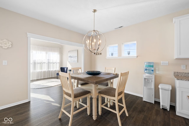 7067 Hart St, Cumberland, IN 46229 - dining room featuring a chandelier, plenty of natural light, dark wood-style floors, and baseboards