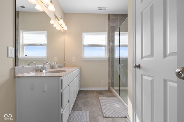 7067 Hart St, Cumberland, IN 46229 - bathroom with double vanity, a tile shower, tile patterned flooring, and baseboards