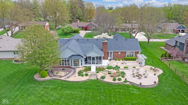 8842 Rocky Ridge Rd, Indianapolis, IN 46217 - back of property featuring brick siding, a chimney, a fenced backyard, and a sunroom